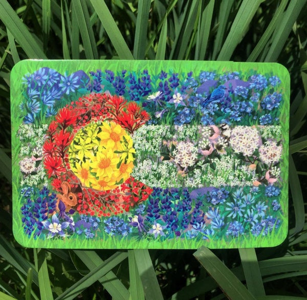 Colorful Colorado wildflower flag sticker with a sun and blue flowers