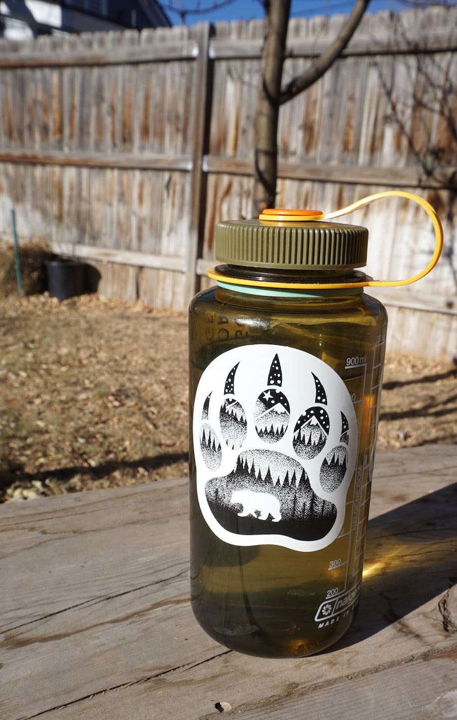 Black-and-white outdoor sticker from the pack displayed on a water bottle