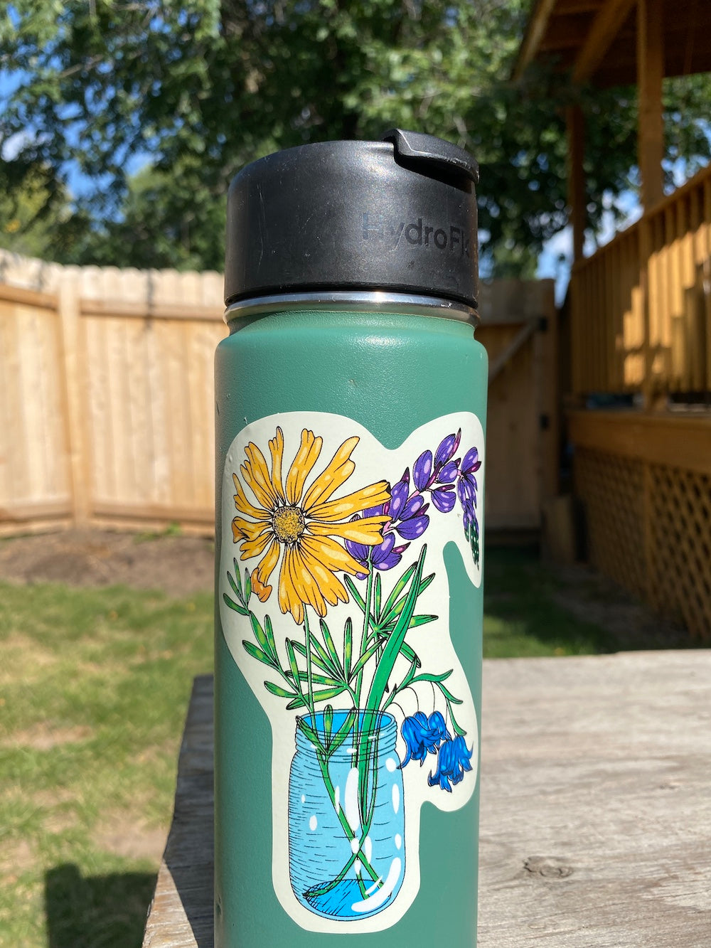 Blue mason jar bouquet sticker with lupine, bluebells and a yellow daisy