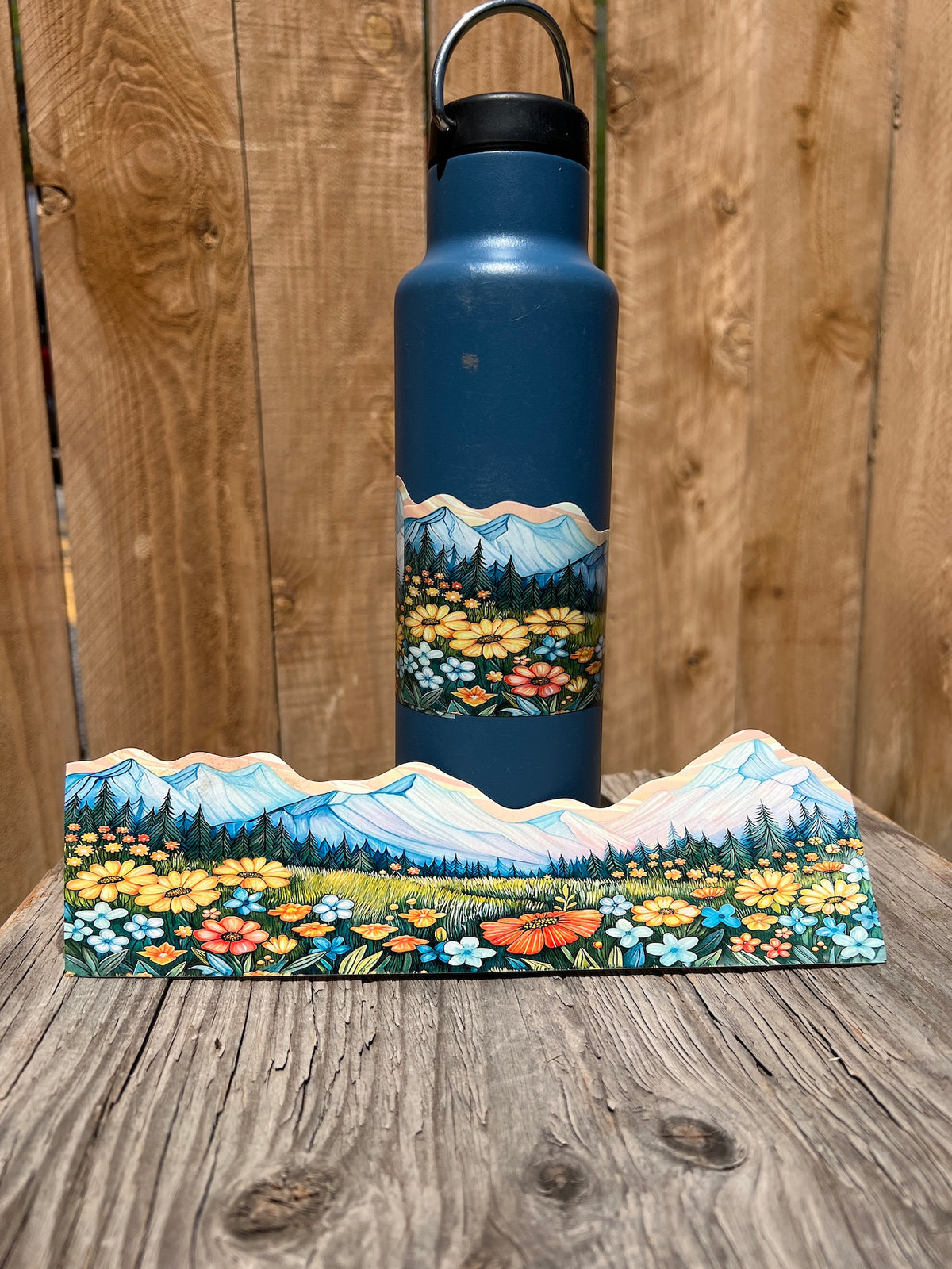 Mountain meadow wildflower wrap-around sticker displayed on a water bottle