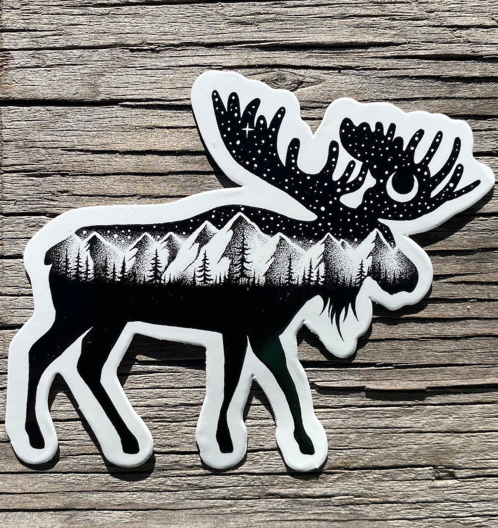 Black-and-white moose, mountain and crescent moon sticker on rustic wood
