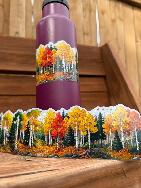 Autumn forest wrap-around sticker applied to a purple water bottle