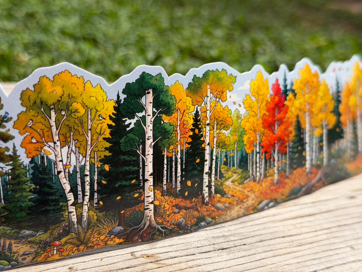 Autumn aspen and evergreen water bottle wrap sticker displayed outdoors