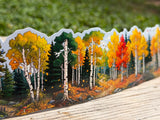 Autumn aspen and evergreen water bottle wrap sticker displayed outdoors