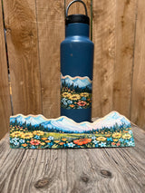 Mountain meadow wildflower wrap-around sticker displayed on a water bottle