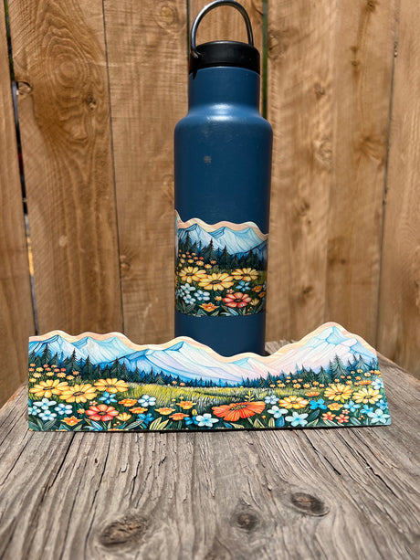Mountain meadow wildflower wrap-around sticker displayed on a water bottle