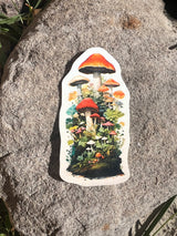 Hand holding a long wildflower meadow water bottle wrap sticker against a wooden background