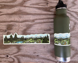 Mountain hiking and lake wrap sticker displayed beside an olive-green water bottle on a wooden background