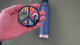 Applying the colorful nature peace sign sticker to a water bottle