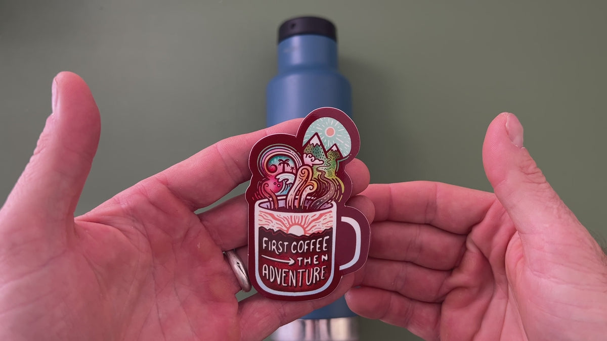 Applying the First Coffee Then Adventure sticker to a water bottle