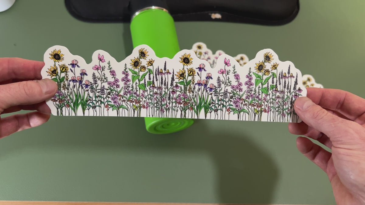 Applying the wildflower garden wrap sticker to a water bottle