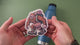 applying Sasquatch camping sticker to blue water bottle