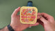 Applying the Take a Trip retro road trip sticker to a water bottle