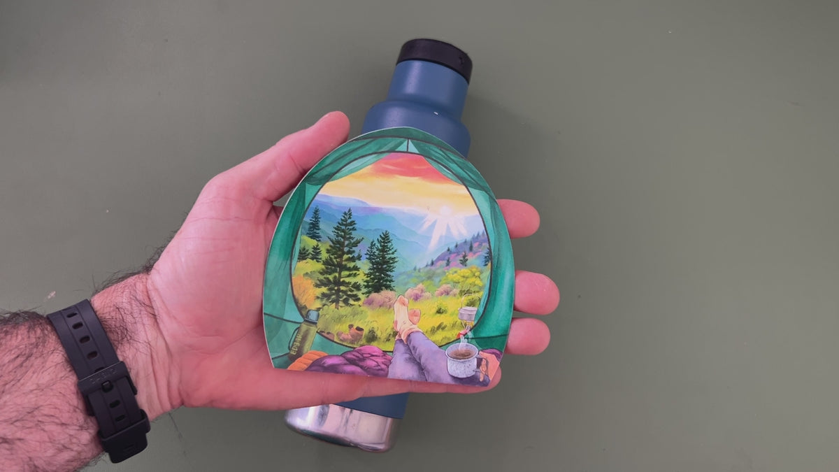 Applying the Colorado mountain camping sticker to a water bottle