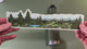 Applying the mountain hiking and alpine lake wrap sticker to a water bottle