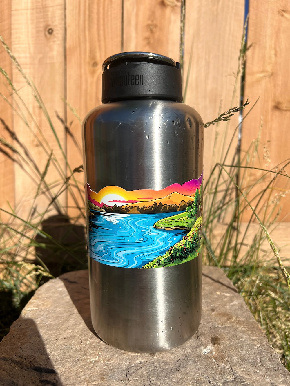 Colorful river sunset water bottle wrap sticker with mountains and forest