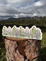 Wildflower garden water bottle wrap sticker displayed in the mountains