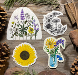 Four wildflower, sunflower, mushroom moon and mason jar floral stickers on rustic wood